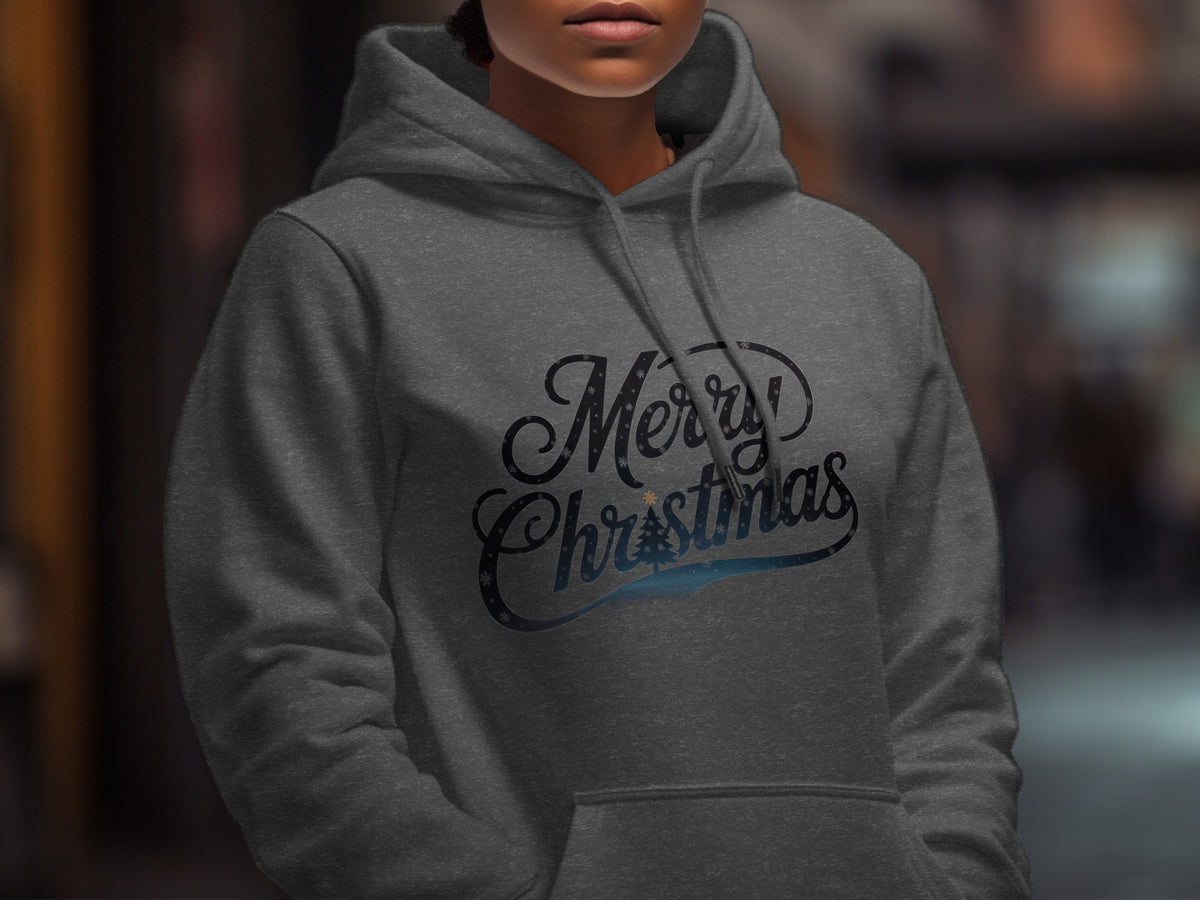 A person wearing a dark grey hooded sweatshirt with the text Merry Christmas printed across the chest.
