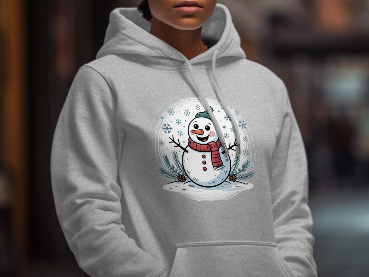 A person wearing a light gray hooded sweatshirt printed with a smiling snowman graphic.