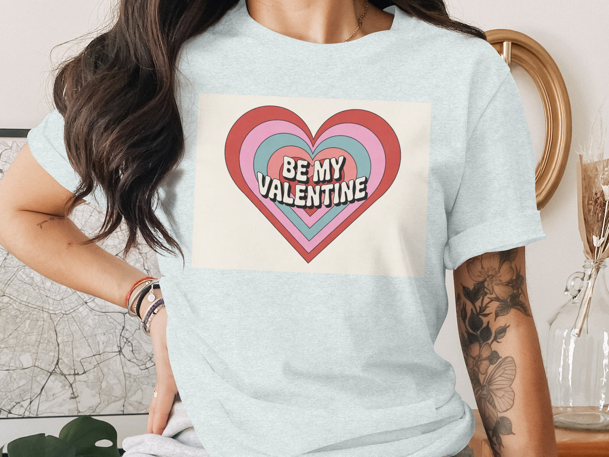 Light blue t-shirt with layered heart graphic saying "BE MY VALENTINE".