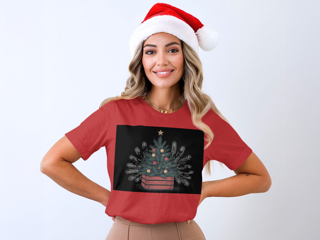 Red t-shirt with Christmas tree illustration and Santa hat on woman.