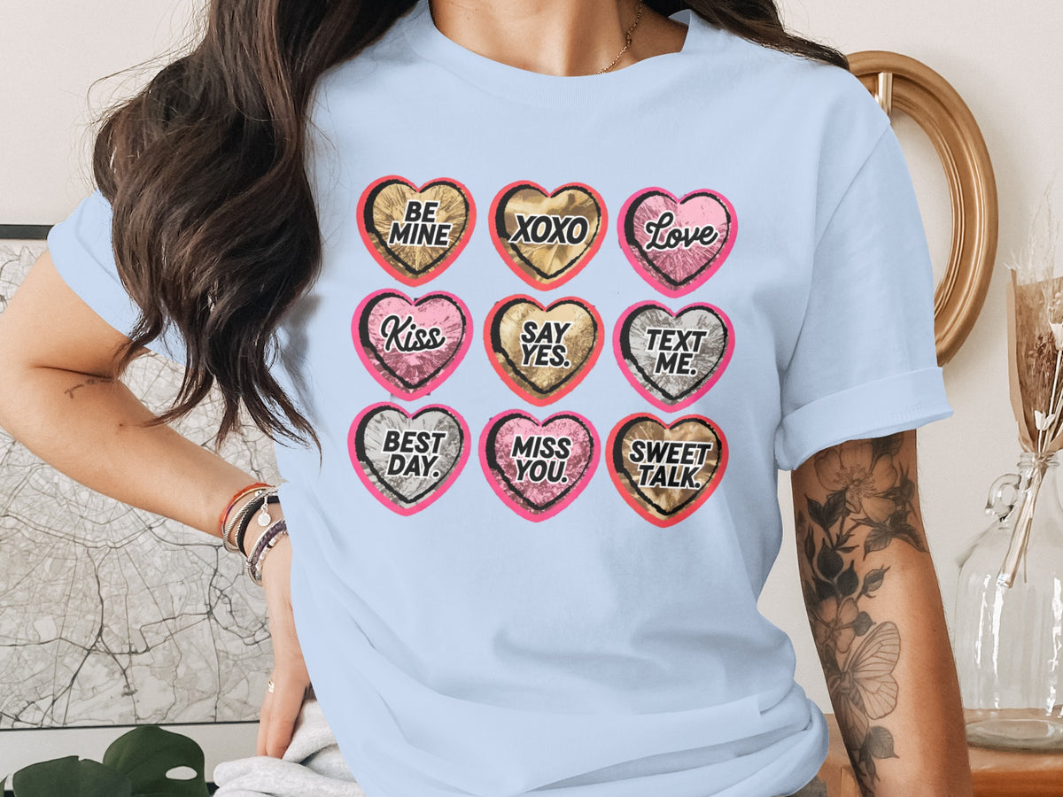 Light blue t-shirt with nine hearts: "BE MINE", "XOXO", "Love", "Kiss", "SAY YES.", "TEXT ME.", "BEST DAY.", "MISS YOU.", "SWEET TALK."