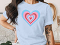 Light blue t-shirt with nested pink and blue hearts graphic.