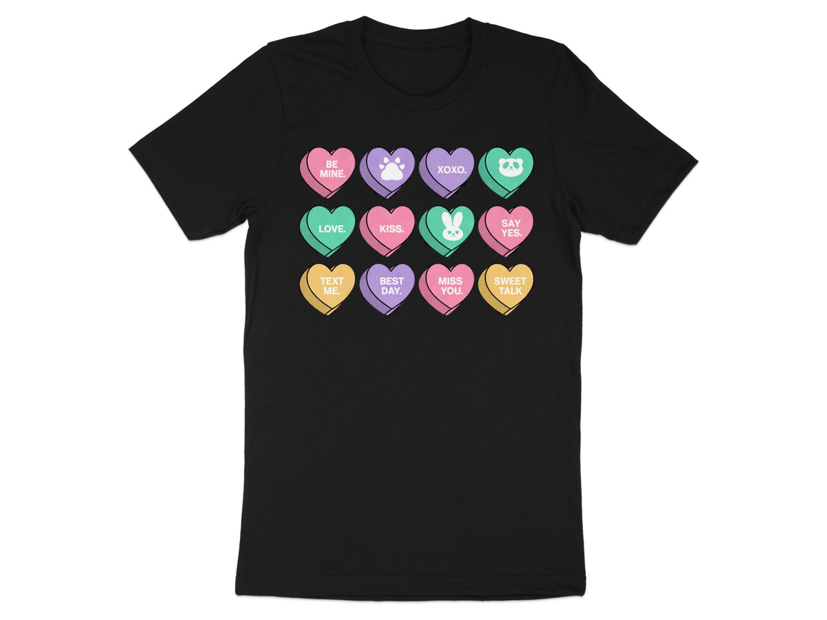 Black t-shirt with a grid of candy hearts featuring text and cute icons.