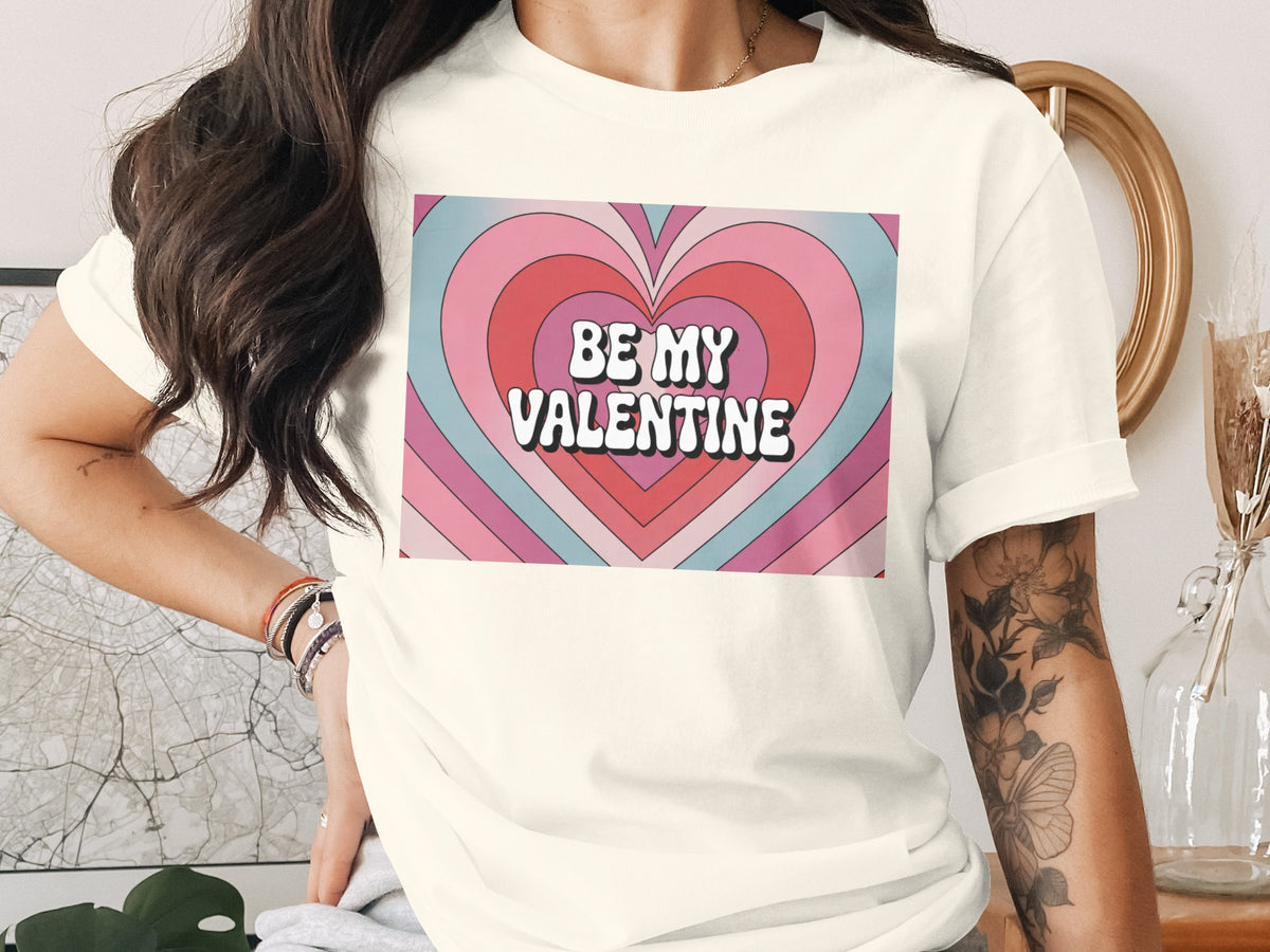T-shirt with "BE MY VALENTINE" text over a colorful heart graphic.