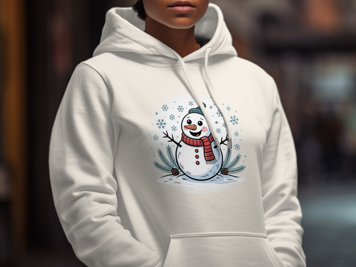 A person wearing a white hooded sweatshirt printed with a smiling snowman illustration.
