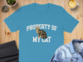 Blue t-shirt with "PROPERTY OF MY CAT" text and a tabby cat graphic.