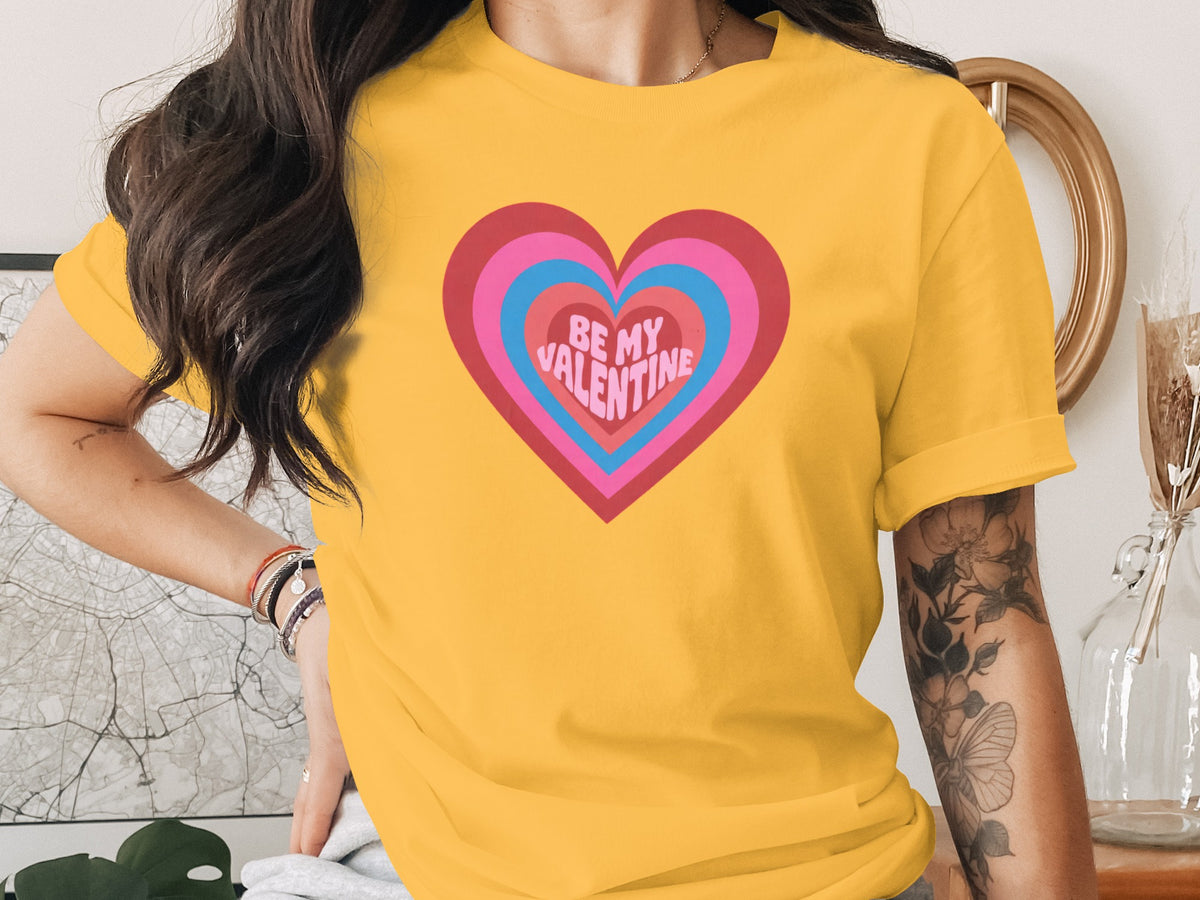 Yellow t-shirt with layered heart graphic and "BE MY VALENTINE" text.