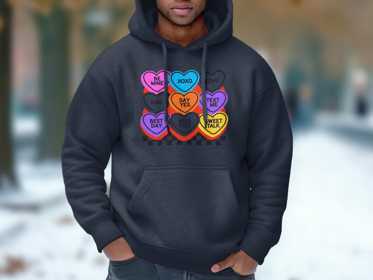 Dark grey hoodie with a graphic of candy hearts saying "Be Mine," "XOXO," "Love," "Kiss," "Say Yes," "Text Me," "Best Day," "Miss You," and "Sweet Talk."