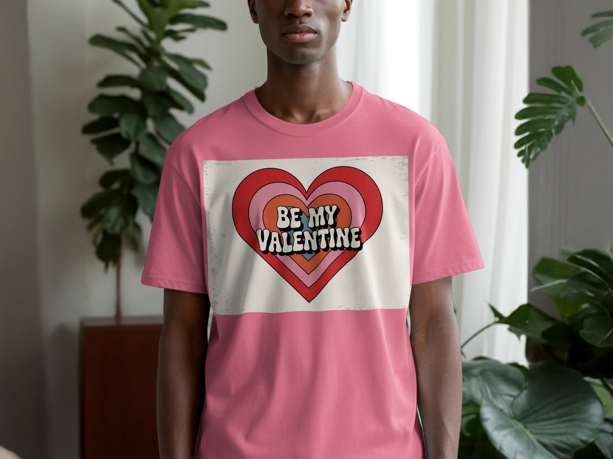 Pink t-shirt with a layered heart graphic reading "BE MY VALENTINE".