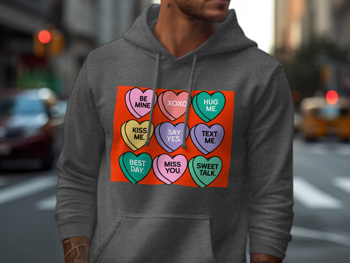 Dark gray hoodie with candy hearts that say "BE MINE", "XOXO", "HUG ME", "KISS ME", "SAY YES", "TEXT ME", "BEST DAY", "MISS YOU", "SWEET TALK".