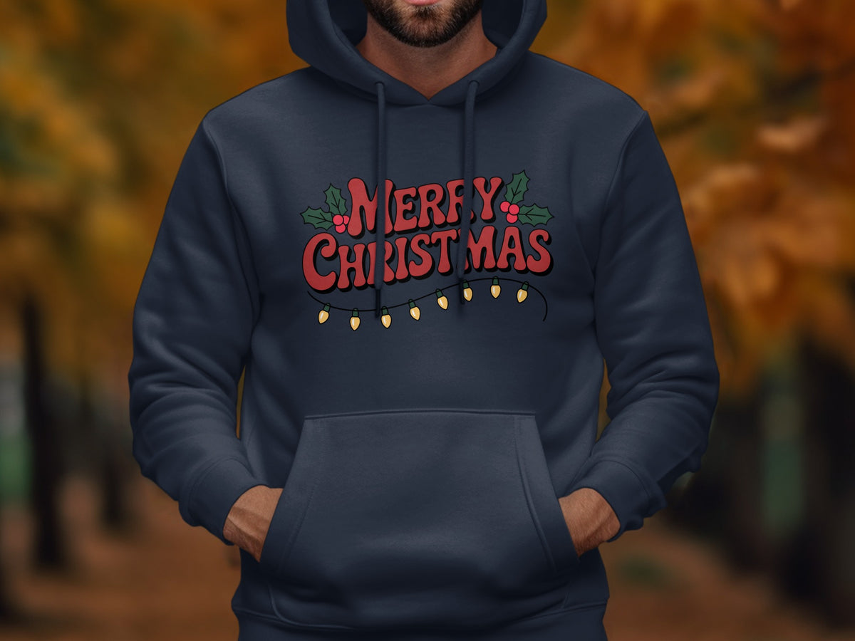 A person wearing a dark blue hoodie printed with red Merry Christmas text and string lights.