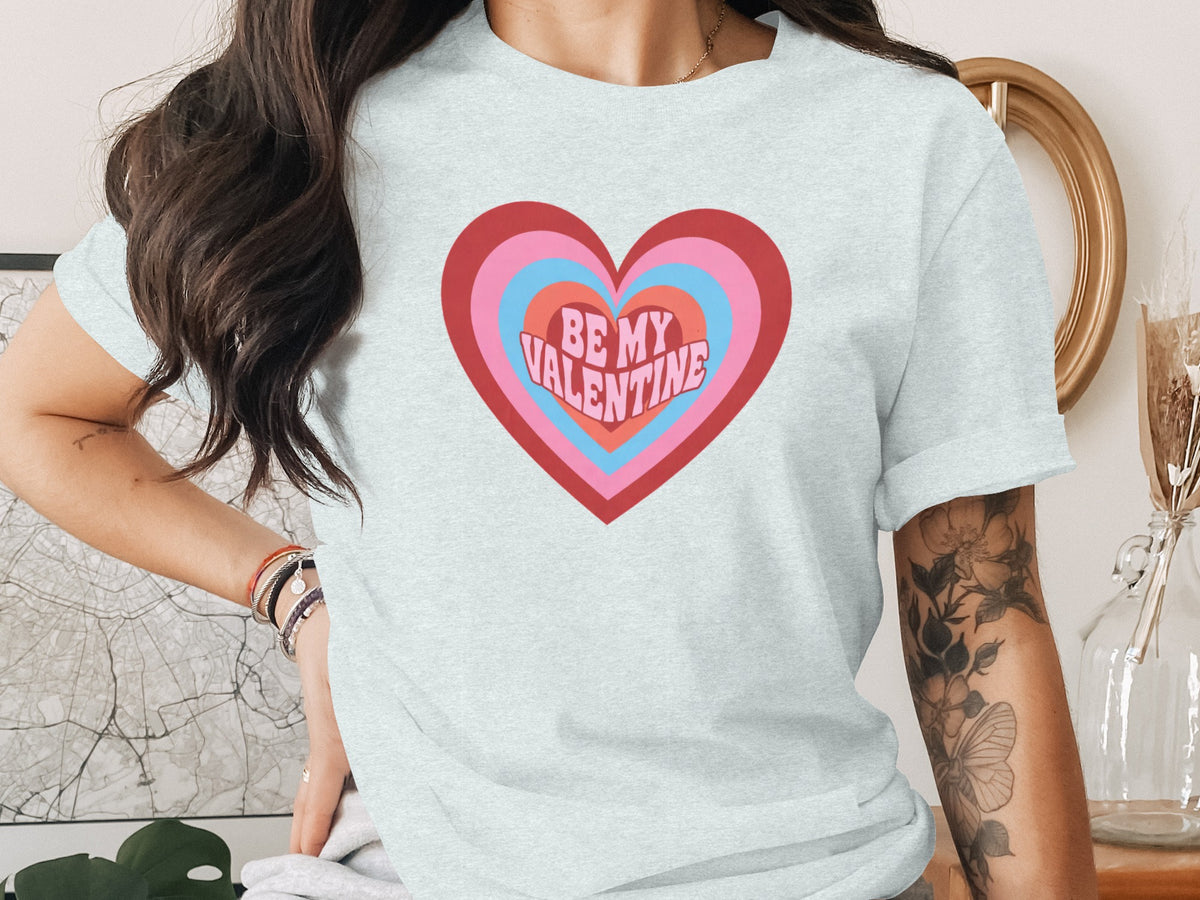 Light grey t-shirt with concentric heart graphic saying "BE MY VALENTINE"