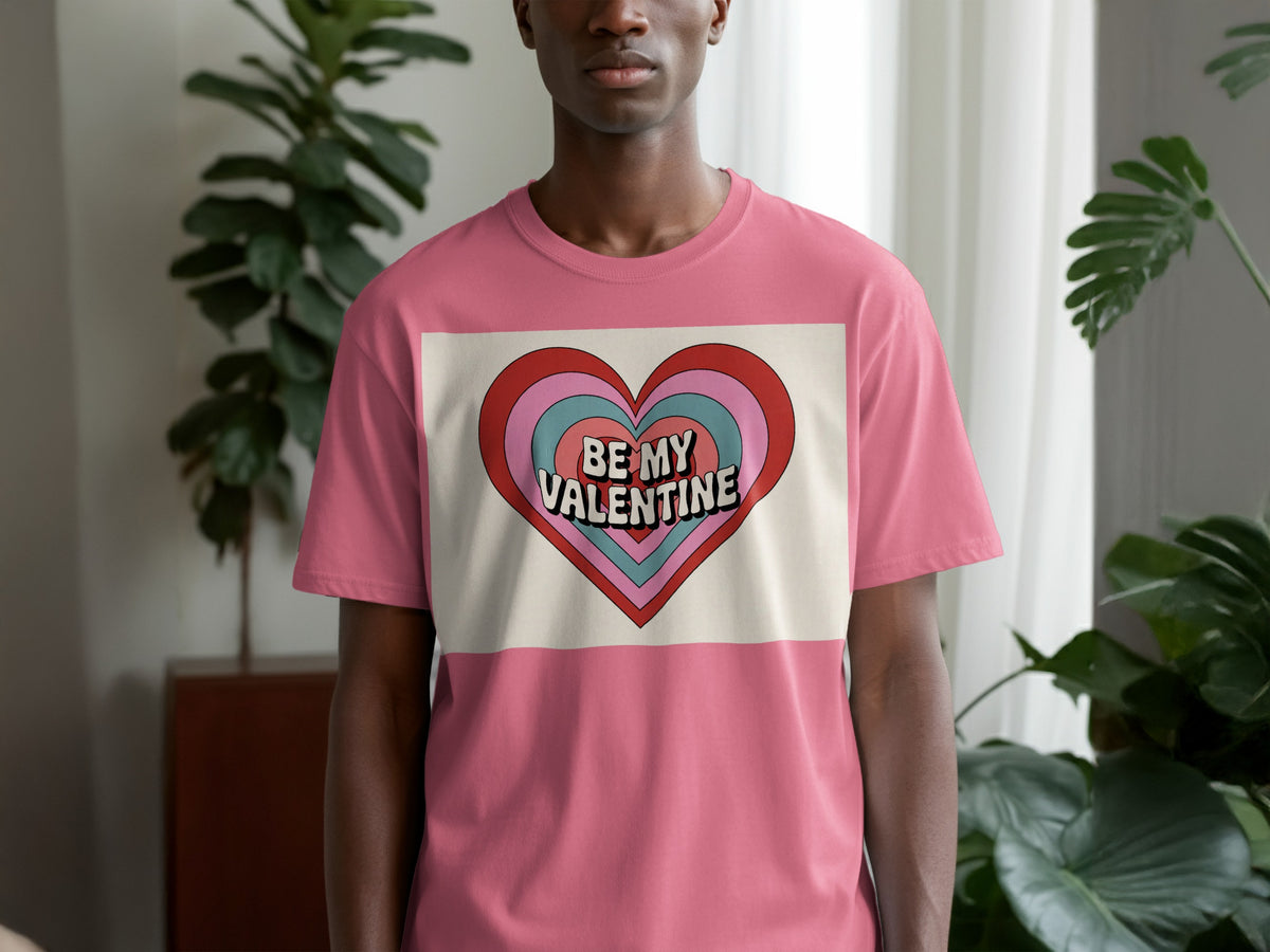 Pink t-shirt on man with "Be My Valentine" text inside colorful heart graphic.