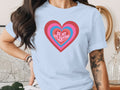 Light blue t-shirt with concentric hearts graphic and "BE MY VALENTINE" text.