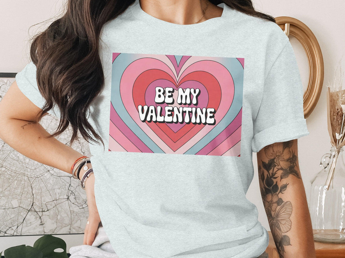 Light blue t-shirt with "Be My Valentine" text over a colorful heart graphic.