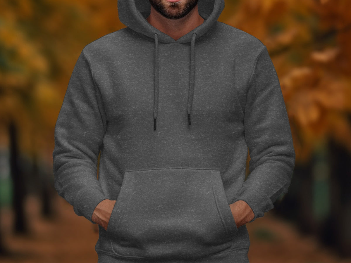 Man wearing a dark gray heathered hoodie with hands in front pocket.