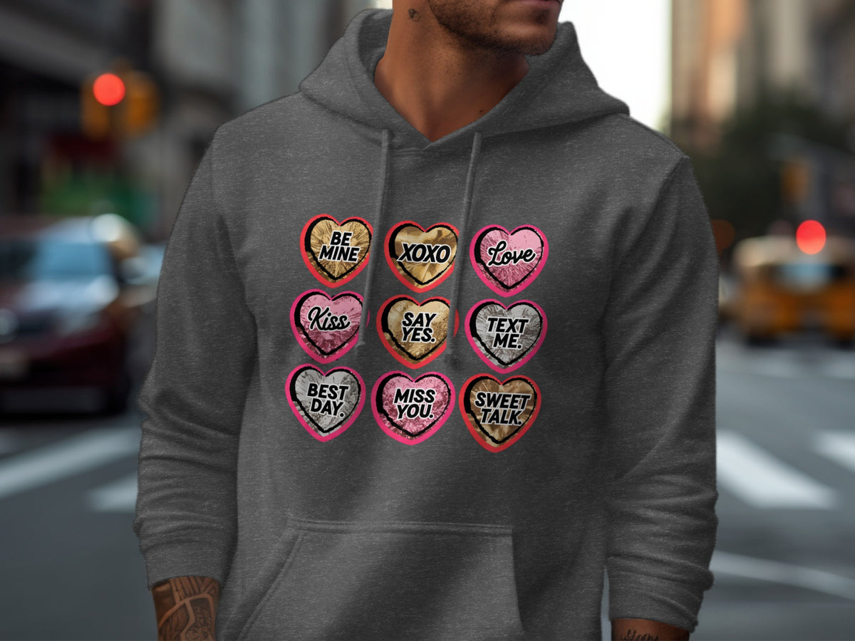 Grey hoodie with nine heart-shaped candy designs including "Be Mine", "XOXO", "Love", "Kiss", "Say Yes", "Text Me", "Best Day", "Miss You", "Sweet Talk".