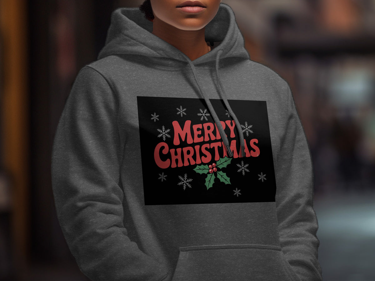 A person wearing a dark gray hoodie printed with red Merry Christmas text and snowflakes.