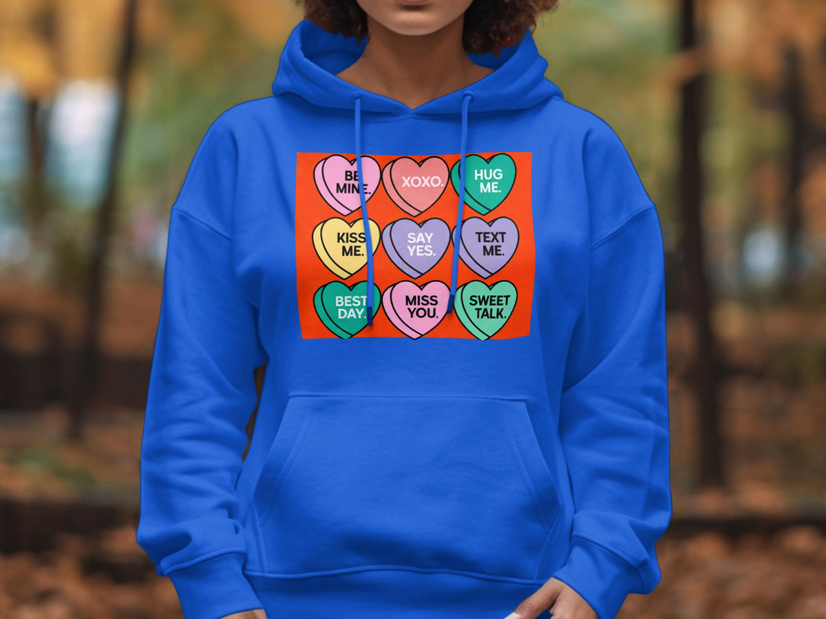 Royal blue hoodie with a graphic of nine conversation hearts containing Valentine's Day messages.