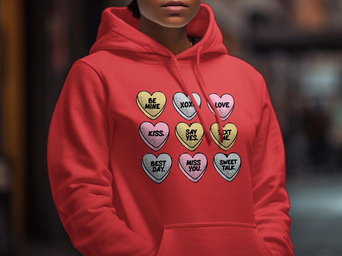 Red hoodie with nine candy hearts: "Be Mine", "XOX", "Love", "Kiss", "Say Yes", "Text Me", "Best Day", "Miss You", "Sweet Talk".