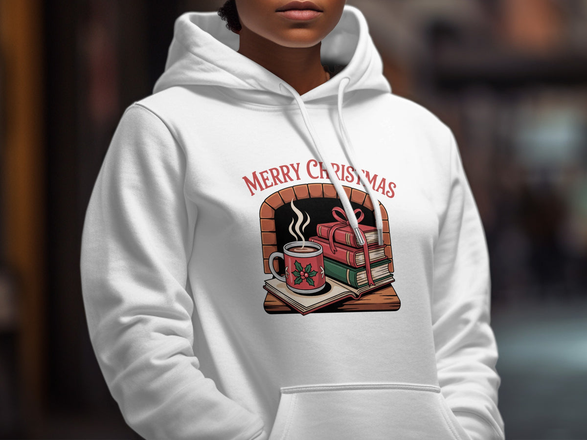 White hoodie with "Merry Christmas" text and a fireplace scene with books and hot cocoa.