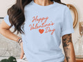 A light blue t-shirt printed with the red text Happy Valentine's Day and a small heart icon.