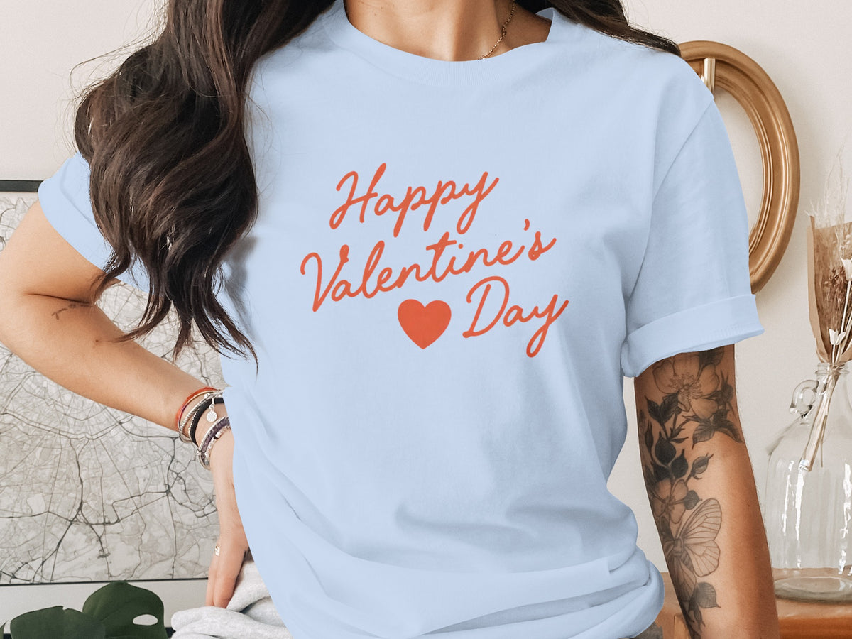 A light blue t-shirt printed with the red text Happy Valentine's Day and a small heart icon.