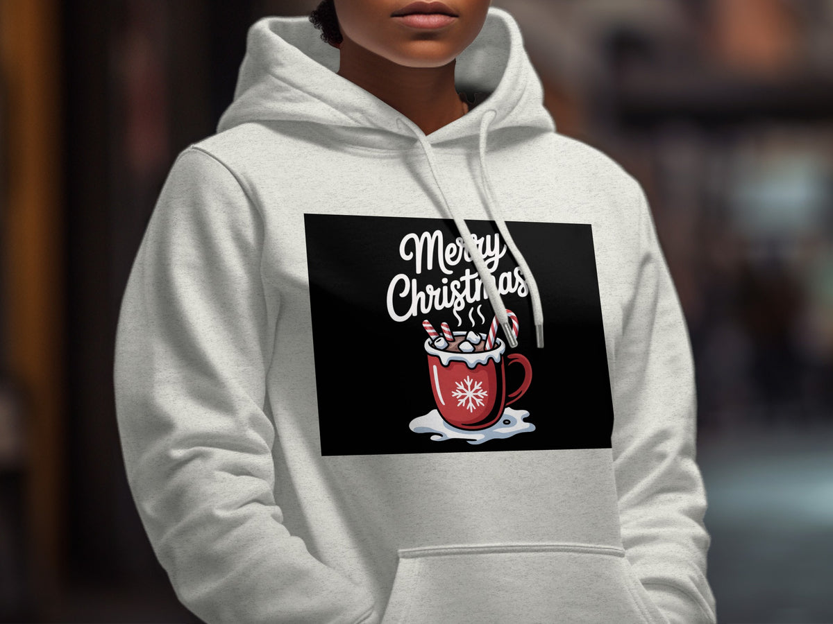 A person wearing a light grey hoodie featuring a graphic of a red Christmas mug.