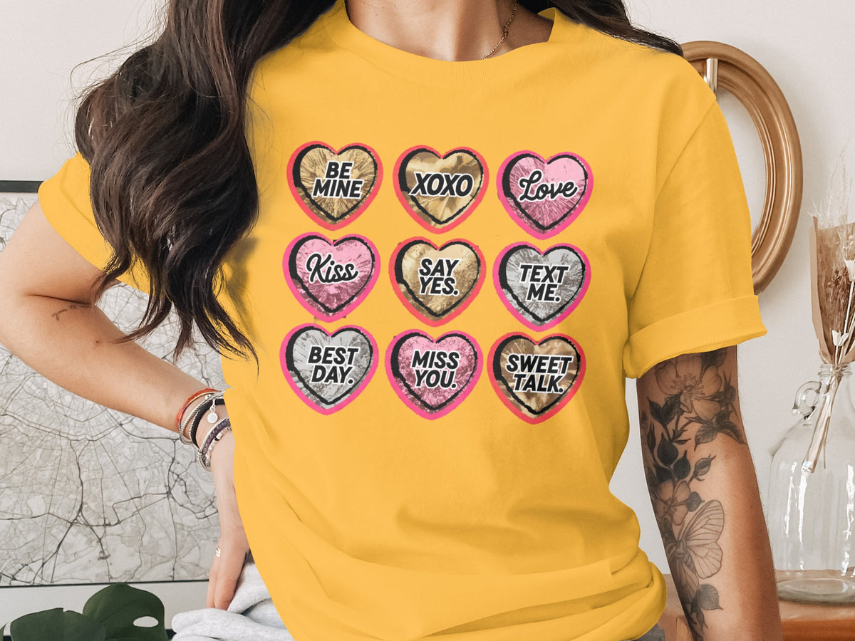 Yellow t-shirt with nine hearts: "BE MINE", "XOXO", "Love", "Kiss", "SAY YES", "TEXT ME", "BEST DAY", "MISS YOU", "SWEET TALK".