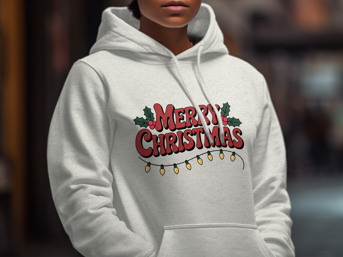 A person wearing a light gray hoodie printed with red Merry Christmas text and string lights.