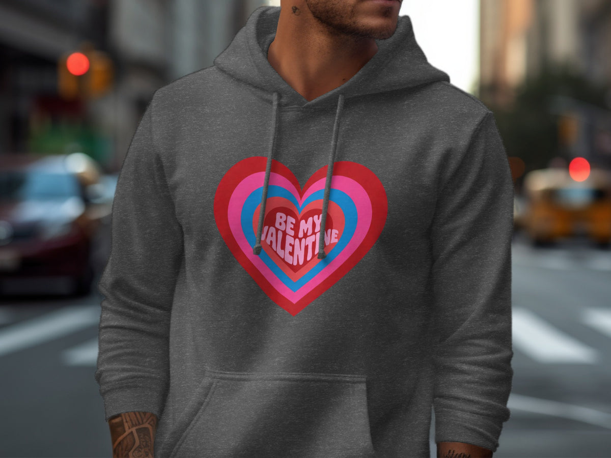 Dark grey hoodie with a graphic heart design and text that reads "BE MY VALENTINE".