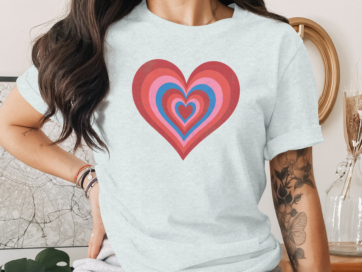 Light blue t-shirt with concentric red and pink hearts.