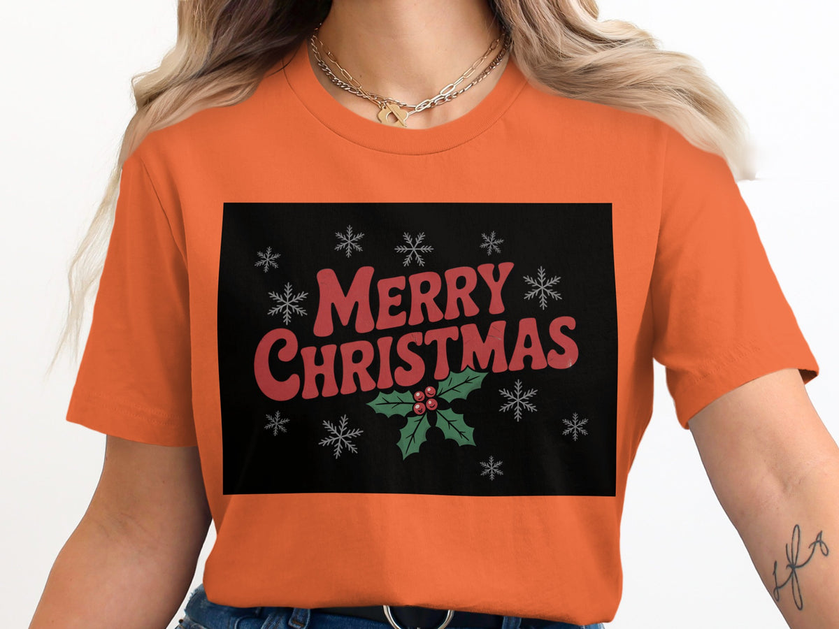 Orange t-shirt with "Merry Christmas" text, holly, and snowflakes graphic.