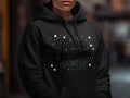Black hoodie with "Merry Christmas" text and holly branch design.