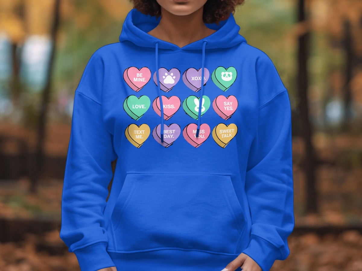 Blue hoodie with candy hearts design: "BE MINE," "LOVE," "XOXO," and others.