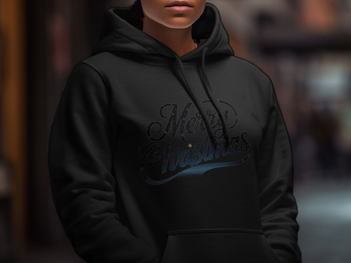 A person wearing a black hooded sweatshirt with the text Merry Christmas printed across the chest.