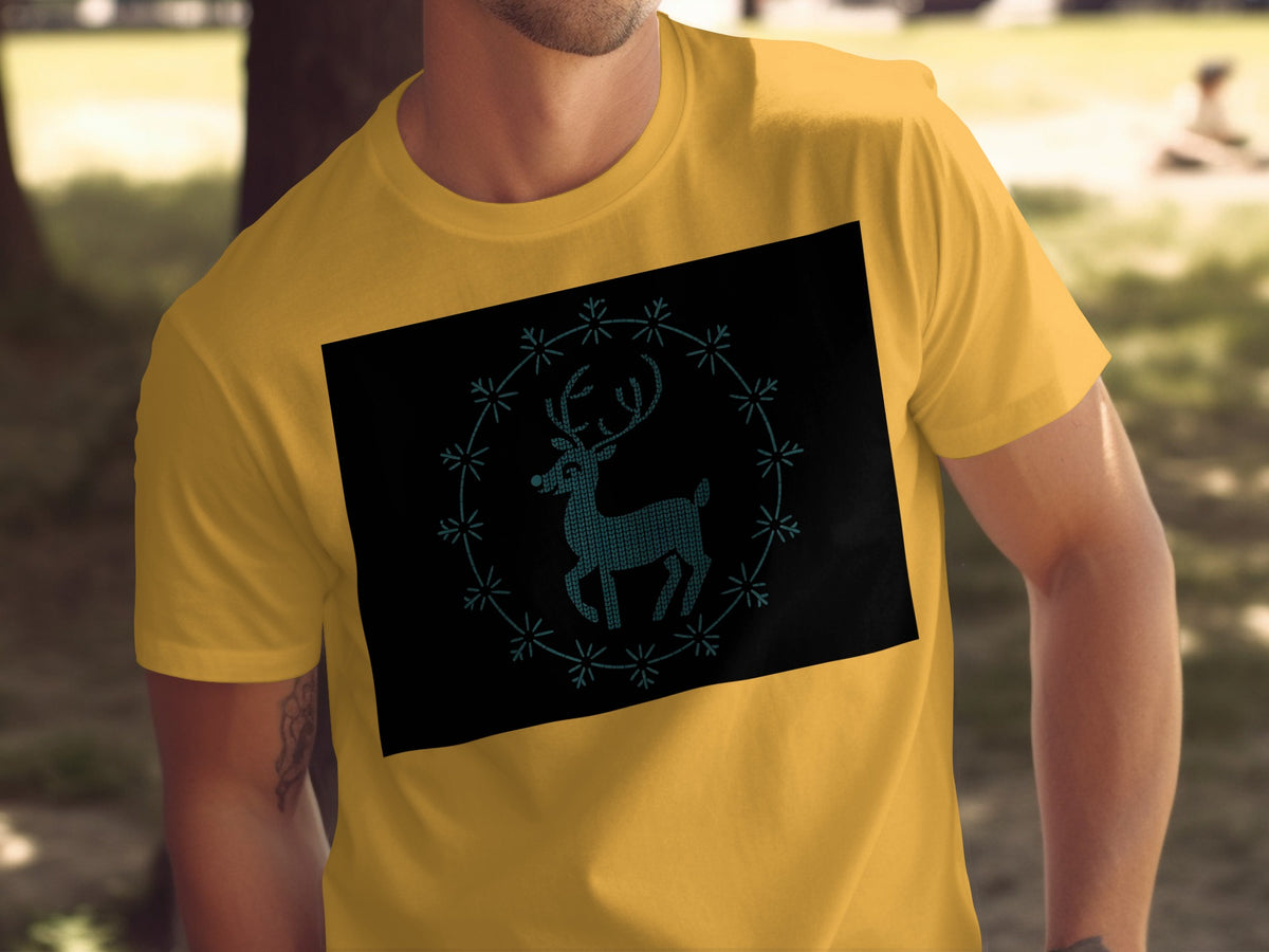 Yellow t-shirt with a black rectangle featuring a teal knit-style reindeer and snowflake border.