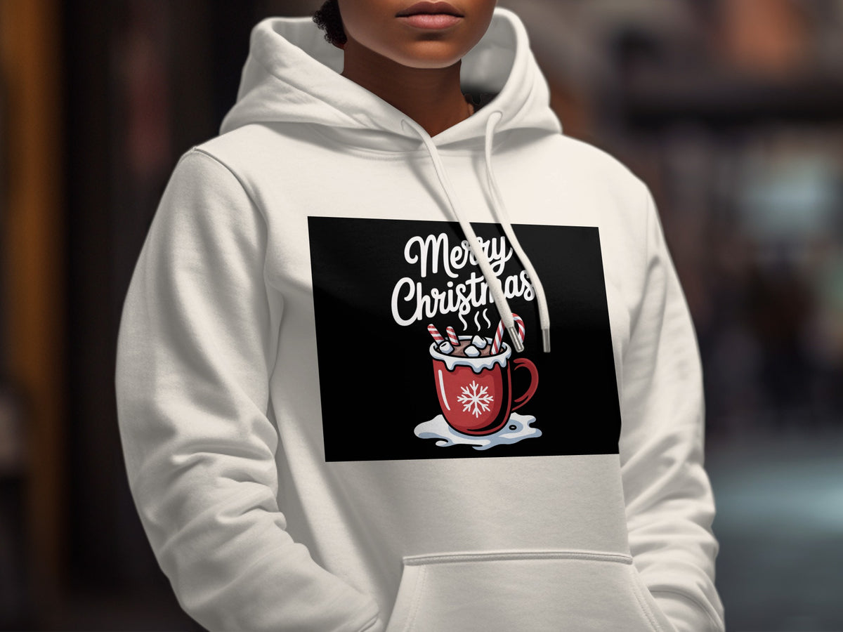 A person wearing a white hooded sweatshirt with a Merry Christmas hot cocoa graphic on the chest.